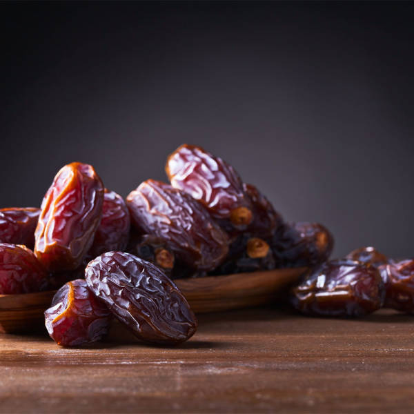 dates in wood dish on table